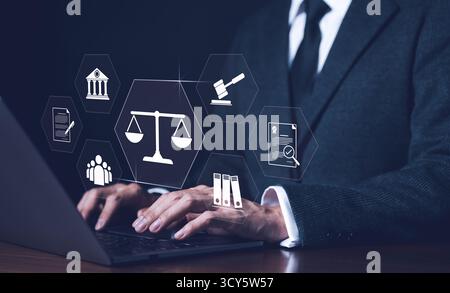 Businessman or Lawyer working with legal services icons on a laptop virtual screen can legal advice online such as labor law for business or company. Stock Photo