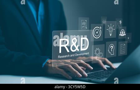 Research and Development, R and D innovation concept. A professional businessman works on a laptop with virtual R&D (Research and Development) Stock Photo