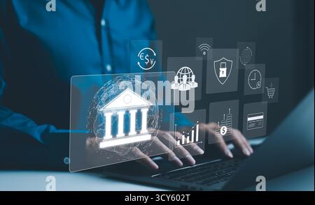 Digital Banking and Financial Technology Concept. Businessman use laptop with digital banking and financial tech icons, currency exchange, security, Stock Photo