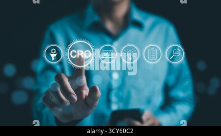 CRO, Conversion Rate Optimization Concept. Businessman pointing at CRO, Other icons include graphs, checklist, and magnifying glass, Stock Photo