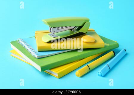 Stapler and other stationery on light blue background Stock Photo