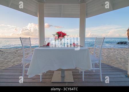 Romantic dinner set up for a couple at the beach in Grenada. Stock Photo