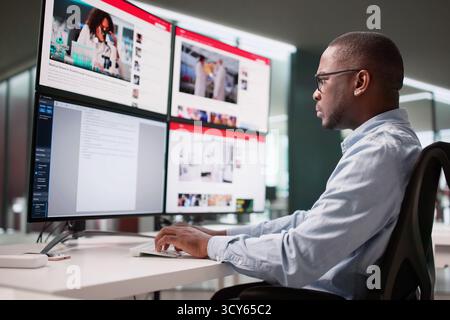 Man Writing Online News Article On African American Business Leader Stock Photo