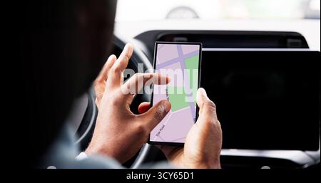 Auto Navigator: Young African American Man Using Smartphone GPS Mapping Stock Photo