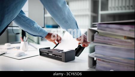 African American Man Works In Modern Office Using OCR Software. Stock Photo