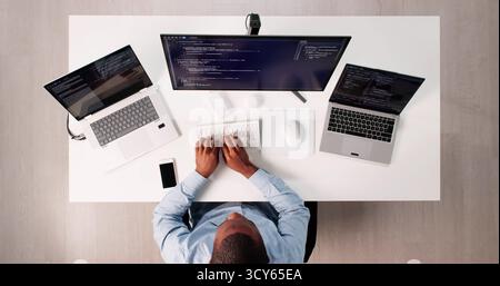 High Angle View Of African American Programmer Man Coding Efficiently Stock Photo