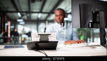 The Young African American Man Is Digitizing Paper Documents. Stock Photo