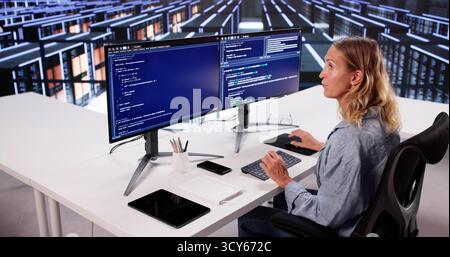 Cloud Computer Engineer Coding In Server Room In Data Center. Configuring AI Technology Stock Photo