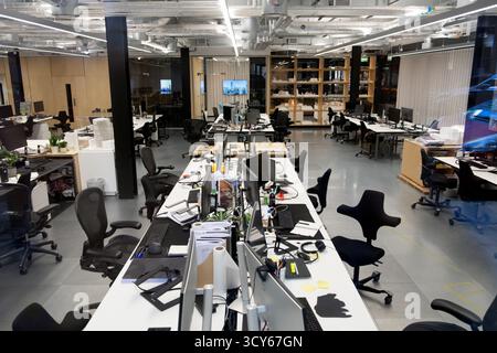 Computers on desks and chairs at work stations in modern City of London office interior London England UK 2025 Great Britain  KATHY DEWITT Stock Photo