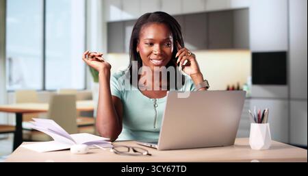 Busy African Woman Coach Speaking On Smartphone From Home Office. Stock Photo