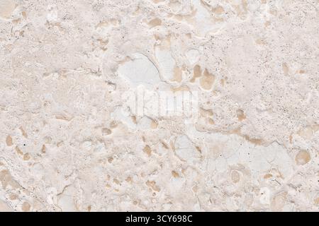 Seamless high-resolution texture of natural limestone or travertine stone. Beige and cream background with natural cracks, fissures, pits, and sedimen Stock Photo