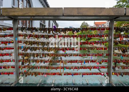 Padlock craze with the meaning of love for two people attached to the bridge over the River Ljubljanica,  in Ljubljana, Slovenia Stock Photo