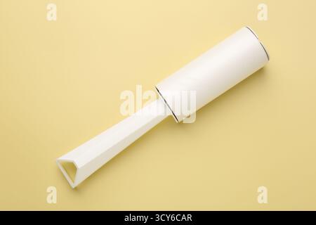 One lint roller on yellow background, top view Stock Photo