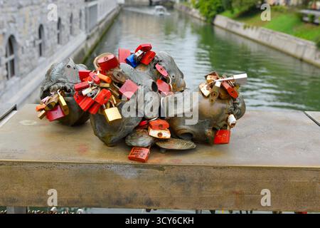 Padlock craze with the meaning of love for two people attached to the bridge over the River Ljubljanica,  in Ljubljana, Slovenia Stock Photo