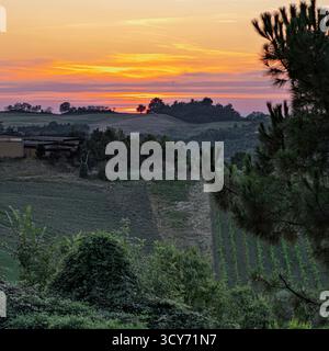 A vivid sunset over the valleys where the Pignoletto wine is produced. Seravalle Castle, Valsamoggia, Metropolitan City of Bologna, Emilia-Romagna, It Stock Photo