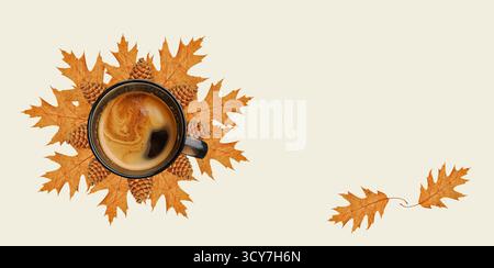 National Coffee Day concept. Gourmet coffee. Fall coffee wallpaper. Coffee cup from above, coffee with foam, dark glass cup, dried oak leaves Stock Photo