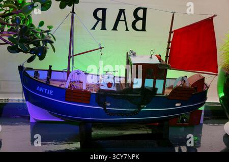model fishing boat displayed by the window in the local pub Stock Photo ...