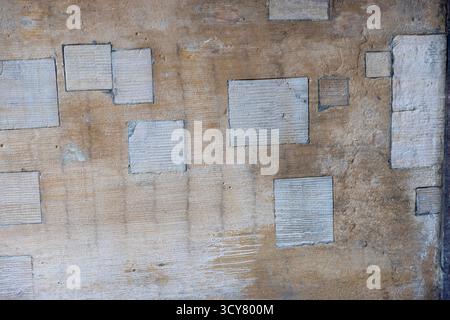 Abstract textured stone wall background with recessed squares Stock Photo