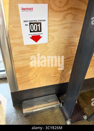 Rentokil pest control inspection point with metal Little Pete mouse trap positioned at base of wall in commercial space - California, USA - October 14 Stock Photo