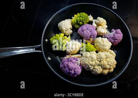Various Winter Vegetables In A Pan: White And Purple Florets Of Cauliflower (Brassica Oleracea Var. Botrytis) And Green, Spiral-shaped Romanesco (Bras Stock Photo