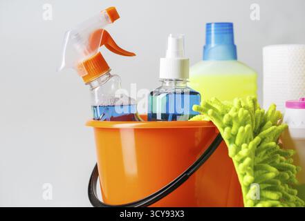 Bucket with cleaning items on light background Stock Photo