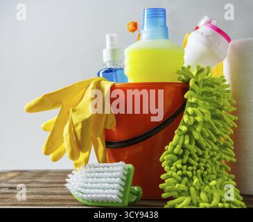 Bucket with cleaning items on light background Stock Photo