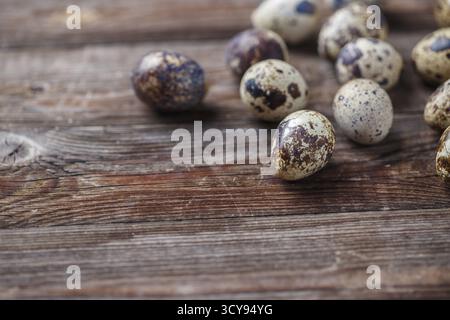 Group of quail eggs on thewooden background. Top view Stock Photo