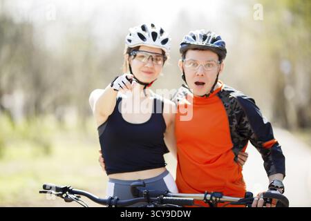 Young cyclists in park during day. Focused on hand Stock Photo