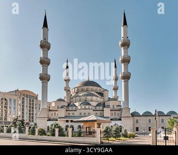 The majestic Bishkek Central Mosque (Imam Sarakhsi) against a clear blue sky. An impressive example of Ottoman-style architecture, featuring a large d Stock Photo