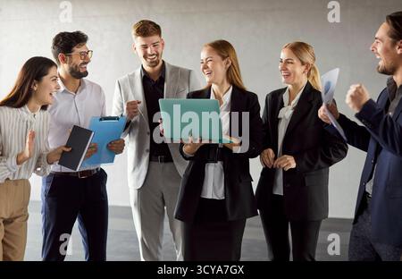 Colleagues Laughing While Collaborating In Office Meeting Stock Photo