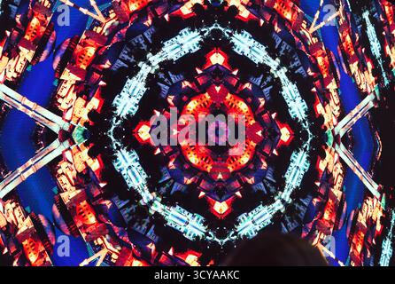 Kaleidoscope patterns in the form of an abstract city in red tones. Stock Photo