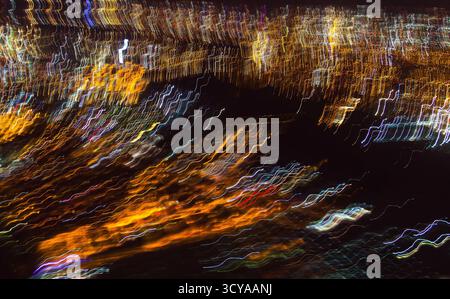 Abstract multi-colored electric discharge in space. Multicolored parallel curved lines in the dark Stock Photo