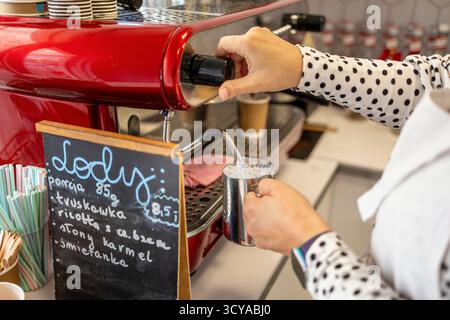 Close-up of female barista preparing coffee in a coffee machine Stock Photo
