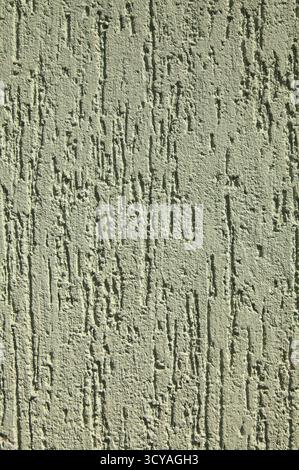 Greenery, embossed wall plastering. Green faded surface, texture, background. Decorated surface with vertical embossed strokes or stripes Stock Photo