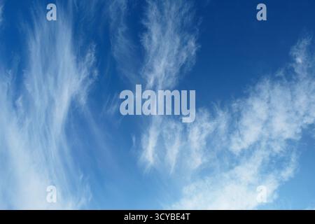 High cirrus clouds against a deep blue sky Stock Photo