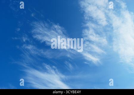 High cirrus clouds against a deep blue sky Stock Photo