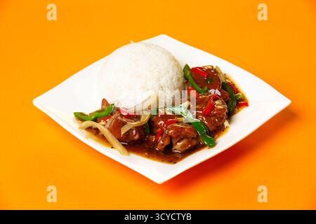 Black Pepper Pork Knuckle with Rice served in plate isolated on orange background side view of hong kong food Stock Photo