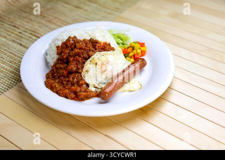 English Breakfast platter include Minced Meat with Rice, Egg, Sausage and mixed vegetables served in plate isolated on table side view of Hong Kong fo Stock Photo