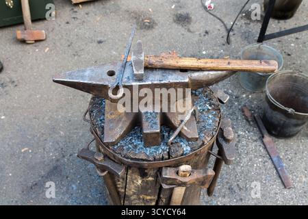 Anvil on a stump. Tools and anvil blacksmith. Stock Photo