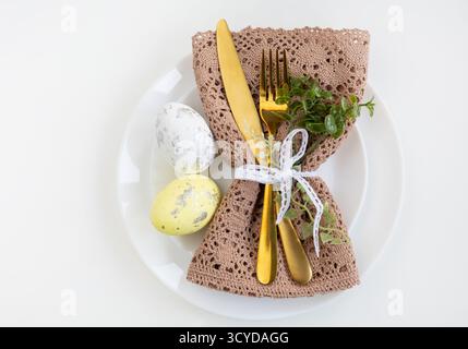 Happy Easter. Easter celebration concept. Top view vertical empty white and yellow plate, Easter eggs, on isolated white background. Copy space, place Stock Photo