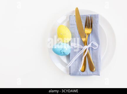 Happy Easter. Easter celebration concept. Top view vertical empty white and yellow plate, Easter eggs, on isolated white background. Copy space, place Stock Photo