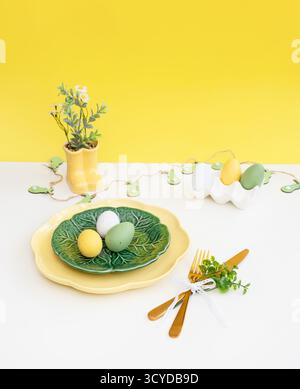 Happy Easter. Easter celebration concept. Top view vertical empty green and yellow plate, Easter eggs, on isolated white background. Copy space, place Stock Photo