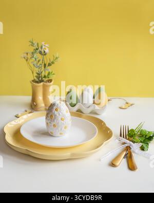Happy Easter. Easter celebration concept. Top view vertical empty white and yellow plate, Easter eggs, on isolated white background. Copy space, place Stock Photo