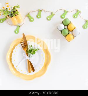 Happy Easter. Easter celebration concept. Top view vertical empty dishes Easter eggs, on isolated pastel background. Copy space, place for text, banne Stock Photo