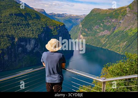 Tourist Overlooking Geiranger Fjord in Norway Stock Photo