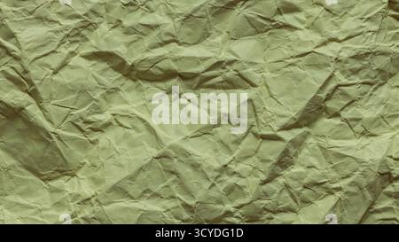 Crumpled Green Paper Texture with Wrinkled Surface Close-Up Stock Photo
