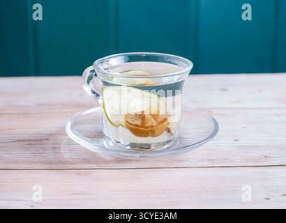 Hot Salted Lemon and Lime Water served in cup isolated on wooden background side view of Hong Kong hot drink Stock Photo