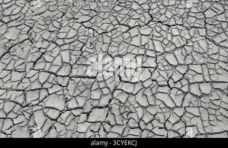 Background texture of dried and naturally cracked white mud from the Comacchio Valley. Province of Ferrara, Emilia-Romagna, Italy Stock Photo