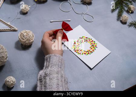 Christmas wreath Gift Christmas idea. Do it yourself instruction postcard eco-friendly decoration. Making handmade presents children's diy projects. Holiday family time. Creative activity Stock Photo