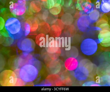 Blue, green, and red bokeh – abstract holiday background with defocused Christmas garland lights Stock Photo